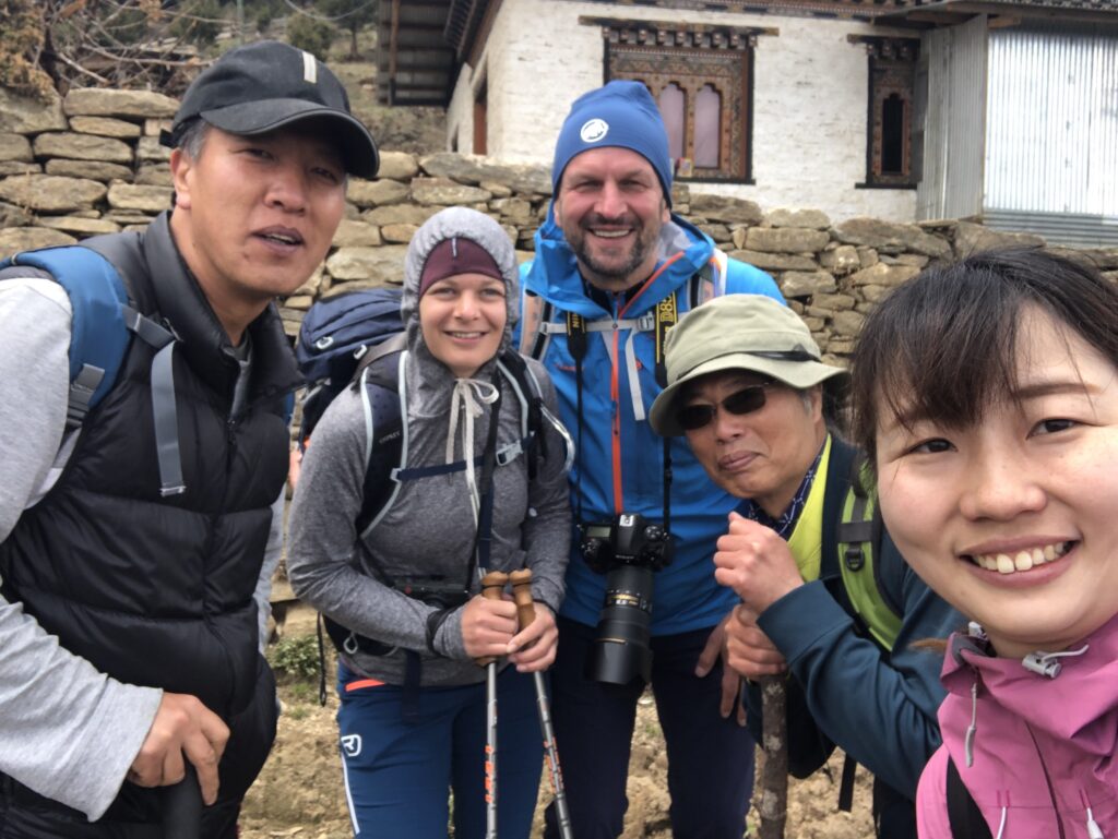 Founder Chencho Gyeltshen personally guiding guests on a scenic day hike to Phobjikha Valley, reflecting Bhutanese hospitality and happiness.